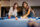 Two young women playing pool