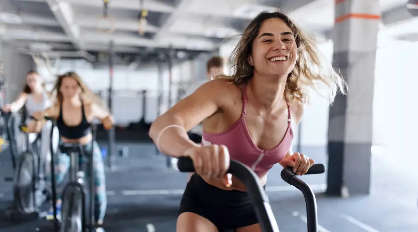 a woman cycling on a stationary bike